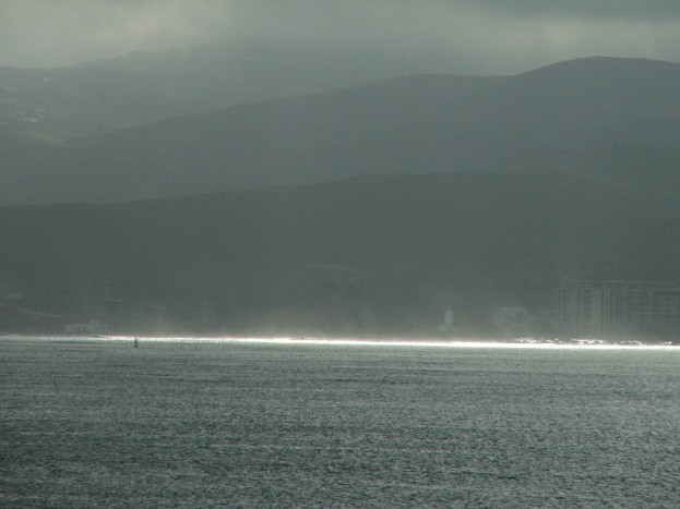 The Atlas mountains rise from the coast of Africa shrouded in rain